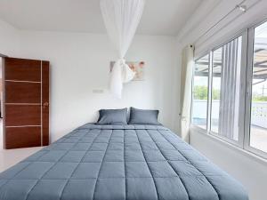 a bedroom with a large bed with a large window at Ban Belife14 in Ban Tha Chin (1)