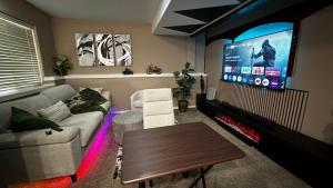 a living room with a couch and a flat screen tv at apartment unit in Spokane