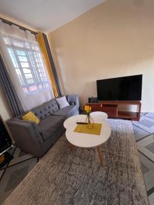 a living room with a couch and a table at The Mountain Gaze in Nyeri