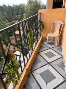 a chair sitting on a balcony with a tiled floor at The Mountain Gaze in Nyeri