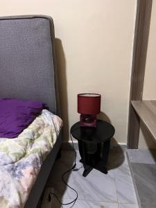 a lamp on a table next to a bed at The Mountain Gaze in Nyeri