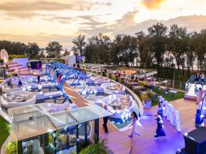a rendering of a water park with a roller coaster at Kora Beach Resort Phuket in Bang Tao Beach