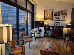 a living room with a table and chairs and a tv at Tycoat in Carantec