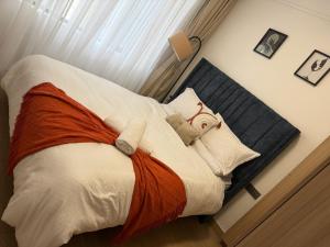 a bedroom with a bed with aultureidered on it at Homiq Stays near UN & Village Market - 1 bedroom in Ruaka +27 photos