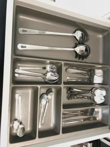 a drawer filled with silver utensils in a kitchen at Apartmantplus02 in Prague +18 photos