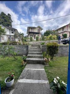 a set of concrete steps leading to a house at Vila Biru Gundaling Brastagi in Berastagi