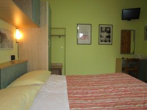 Postel nebo postele na pokoji v ubytování Albergo Primavera