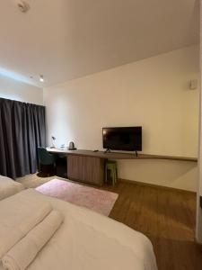 a hotel room with a flat screen tv on the wall at Putra Hotel at Mydin Tunjong in Kota Bharu +7 photos