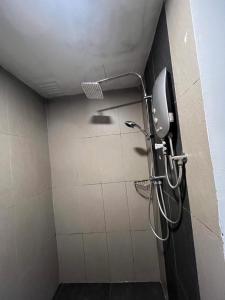 a shower in a bathroom with a shower head at Putra Hotel at Mydin Tunjong in Kota Bharu