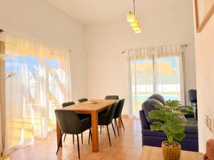 a dining room with a table and chairs at Villa Solara in Caleta De Fuste