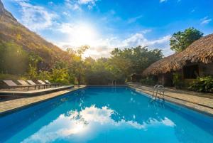a swimming pool at a resort with at Hang Lan Ecolodge in Ninh Binh