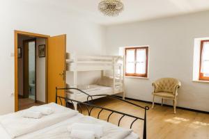 a room with two bunk beds and a chair at Apartment Valetovi in Štanjel
