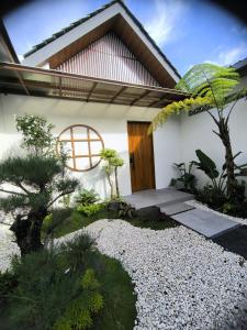a house with a zen garden in front of it at Agarra Villa in Yogyakarta