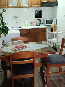 a kitchen with a table with a plate of food on it at Apartman Centar in Grude