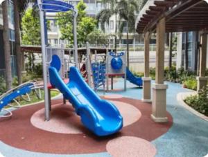 a playground with a blue slide in a park at The Layover Condotel ,Palm Tree two Villas ,cluster 2 - unit 7q , New Port Boulevard , Newport City ,NAIA Terminal 3 , Pasay City , Philippines in Sampong
