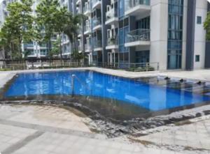 a large blue swimming pool in front of a building at The Layover Condotel ,Palm Tree two Villas ,cluster 2 - unit 7q , New Port Boulevard , Newport City ,NAIA Terminal 3 , Pasay City , Philippines in Sampong