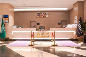 a lobby of a hospital with flags on the floor at Finda Hotel in Medina