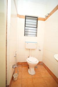 a bathroom with a toilet and a sink at HOTEL ABHISHEK, Shirdi in Shirdi +11 photos