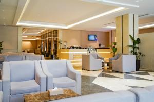 a lobby with white chairs and a waiting room at Finda Hotel in Medina