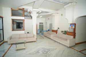 a lobby with couches and a table in a building at HOTEL ABHISHEK, Shirdi in Shirdi