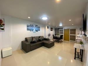 a living room with a couch and a table at NB Bangsaen House in Ban Puk (2)