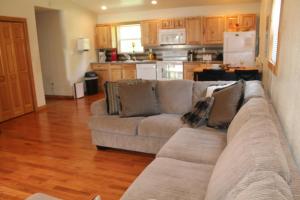 a living room with a couch and a kitchen at Pipestem Spa, Event Center and Mountain Chalets in Pipestem