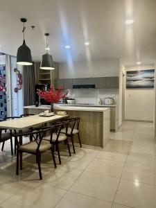 a kitchen and dining room with a table and chairs at Oceanami Resort beach club in Long Hai
