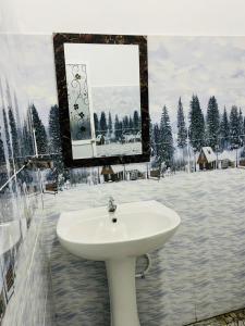 a bathroom with a white sink and a mirror at Kumara Guest House Dambulla in Dambulla