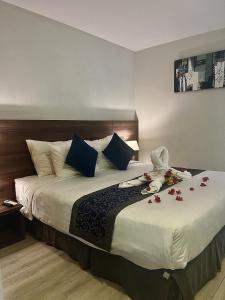 a hotel room with a bed with flowers on it at Oceanami Resort beach club in Long Hai