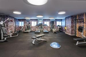 a gym with a large room with weights and machines at Hotel Rothschild 22 - FATTAL COLORS in Tel Aviv