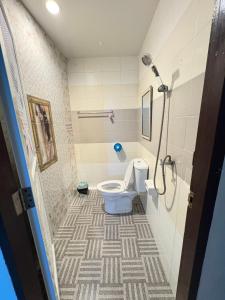 a bathroom with a toilet and a shower at NB Bangsaen House in Ban Puk (2)
