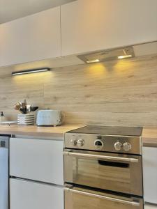 a kitchen with a stainless steel stove top oven at Maison Les Sardines in Cucq