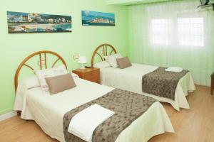 מיטה או מיטות בחדר ב-Hostal Buenavista