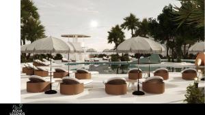 a group of chairs and umbrellas next to a pool at Flow Aqua Legends Resort Sahl Hasheesh in Hurghada