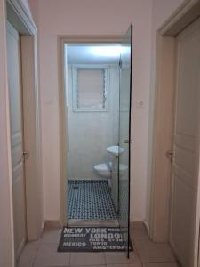 a mirror in a bathroom with a toilet at Nafplia Guesthouse 1 in Nafplio +40 photos