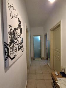 a drawing of a bicycle on a wall in a hallway at Nafplia Guesthouse 1 in Nafplio
