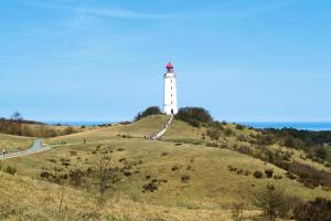 a lighthouse sitting on top of a hill at Appartements Post Hiddensee, Vitte in Vitte +80 photos