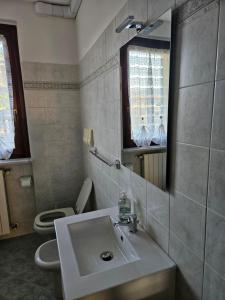 a bathroom with a sink and a toilet and a mirror at Casa Francesca in Villongo SantʼAlessandro +16 photos