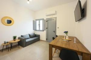 a living room with a table and a couch at Aerial Apartments in Karterados