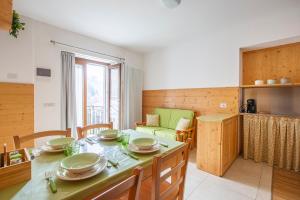 a kitchen and living room with a table and chairs at Il Nido di Somadino in Casargo +4 photos