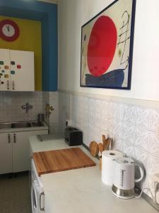 a kitchen with a sink and a counter top at Delightful apartment 100 meters from the Colosseum in Rome