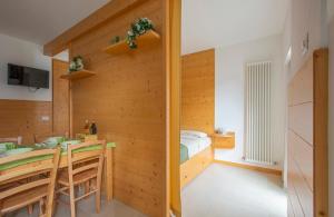 a room with a table and a bed and a dining room at Il Nido di Somadino in Casargo
