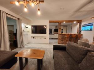 a living room with a couch and a table at Bachhaus Marktredwitz Haupthaus in Marktredwitz