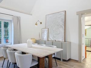 a dining room with a table and chairs at Beautiful longere with pool in Courcelles-lès-Gisors
