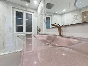 a bathroom with a large pink tub in a room at Beautiful longere with pool in Courcelles-lès-Gisors +23 photos