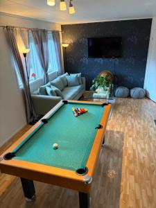 a living room with a pool table in it at JOlster apartaments - lake view in Årdal