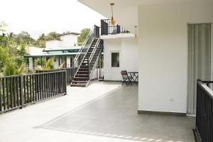 a balcony with a staircase in a house at Meadow Breeze in Kandy