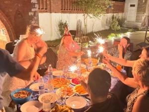 a group of people sitting around a table with sparklers at Citadel Luxor in Luxor +106 photos