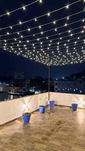 a row of blue pots on a roof with lights at Mihira Homestays in Hanamkonda