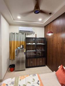 a room with a refrigerator in the corner of a room at Mihira Homestays in Hanamkonda